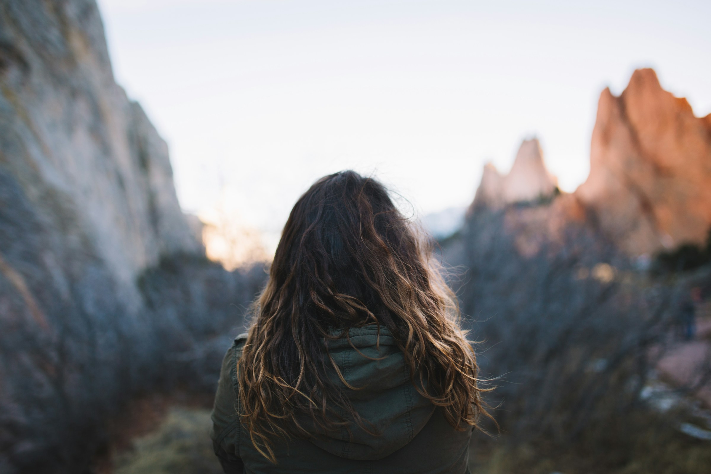 Woman facing mountains at daytime.