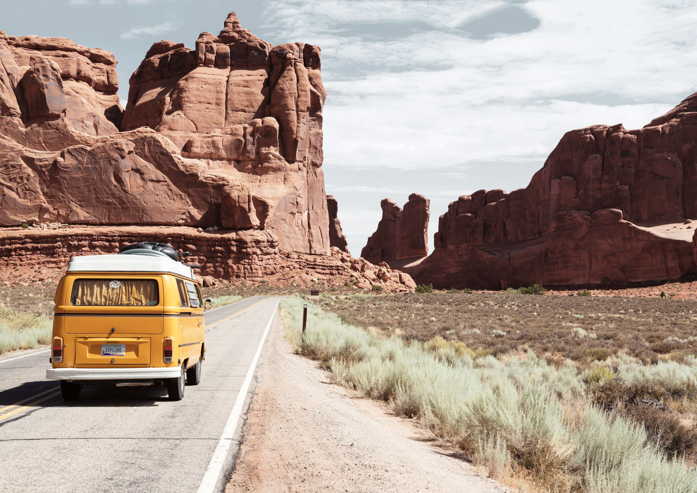 Yellow Volkswagen van on road.