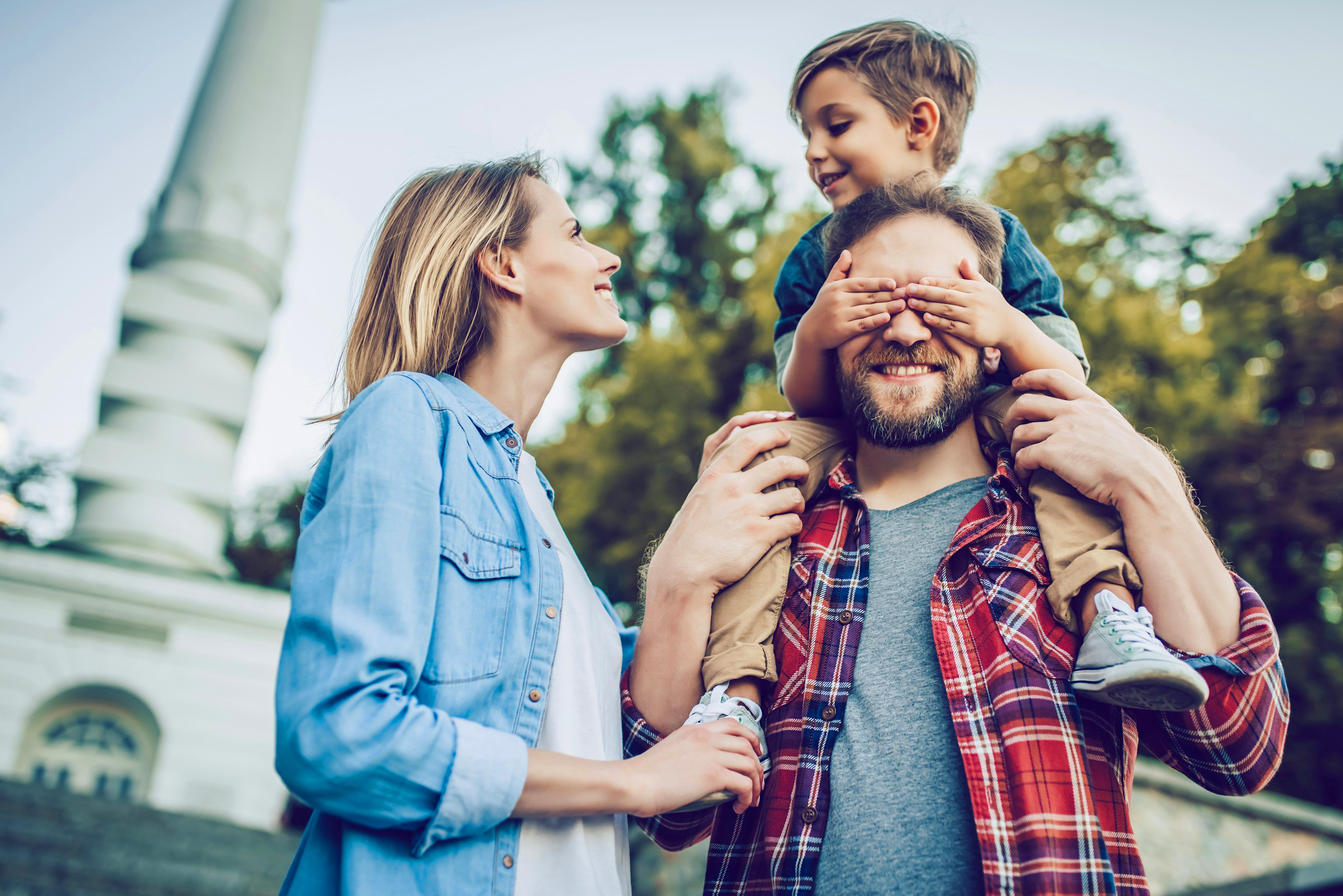 Happy family is having fun outdoors. Father, mother and son are spending time together.